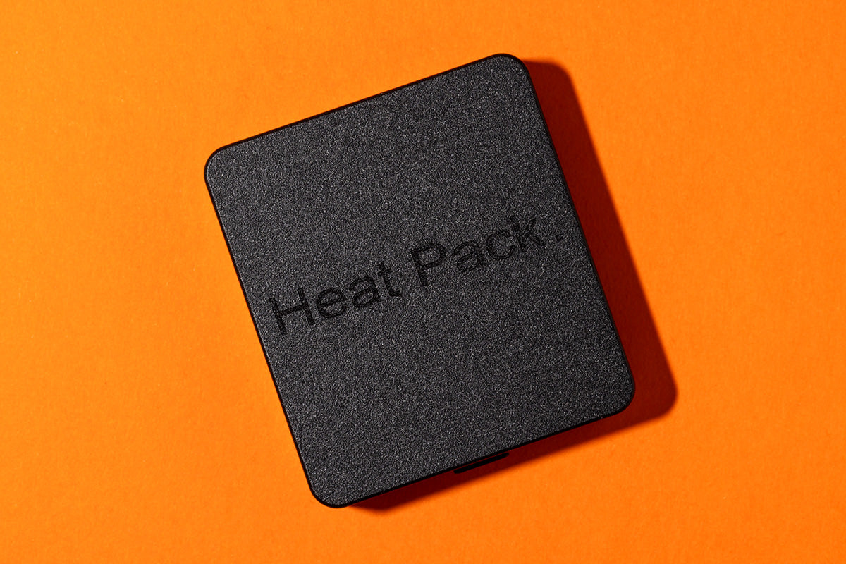 Black aluminum rectangle with Heat Pack etched into the surface