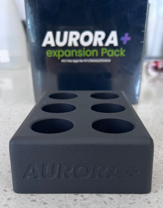 Black metal box with 6 holes for root plugs. Labeled Aurora+