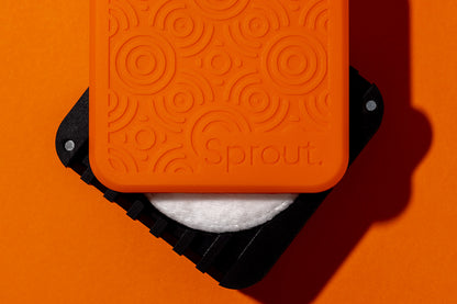 Orange and black silicone seed germination chamber on orange background