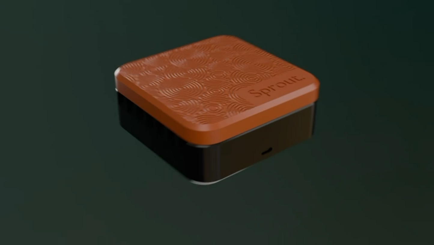 Orange and black silicone seed germination chamber against a dark green background