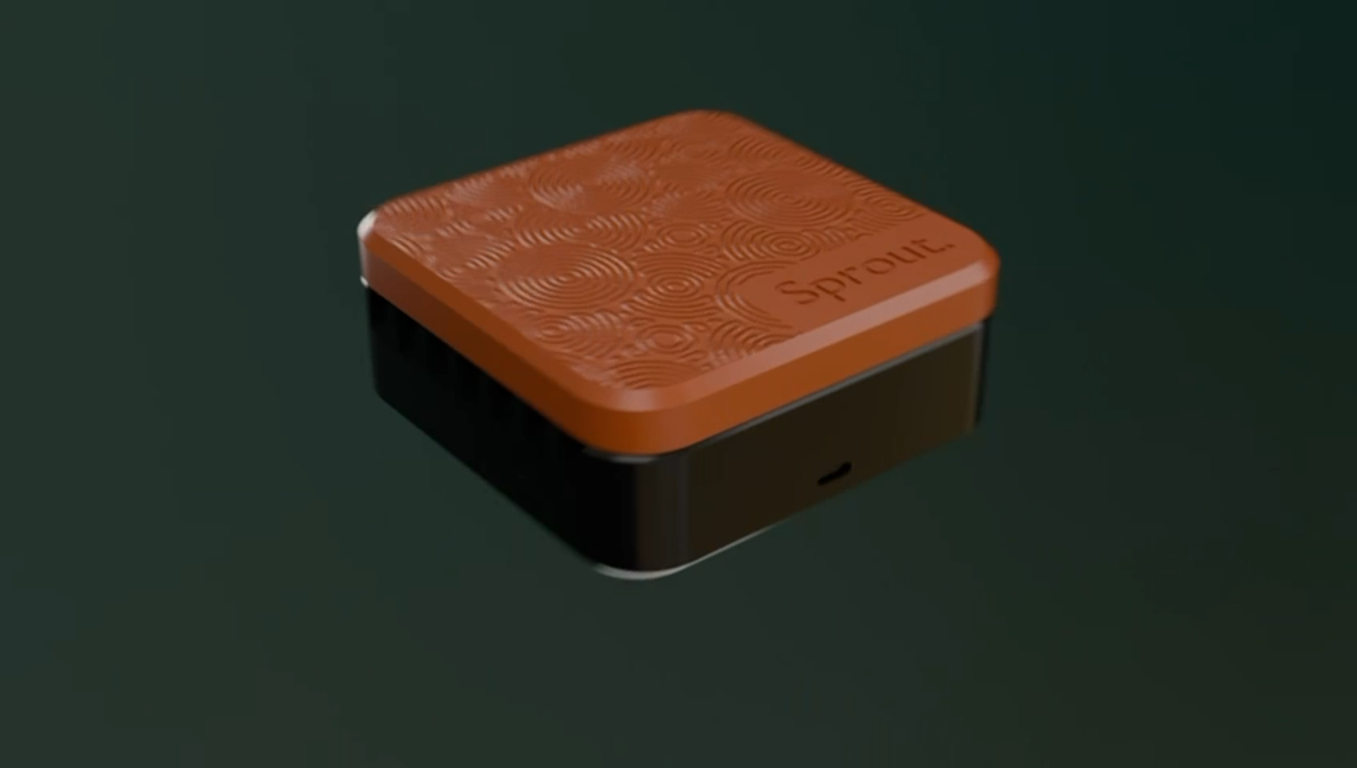 Orange and black silicone seed germination chamber against a dark green background